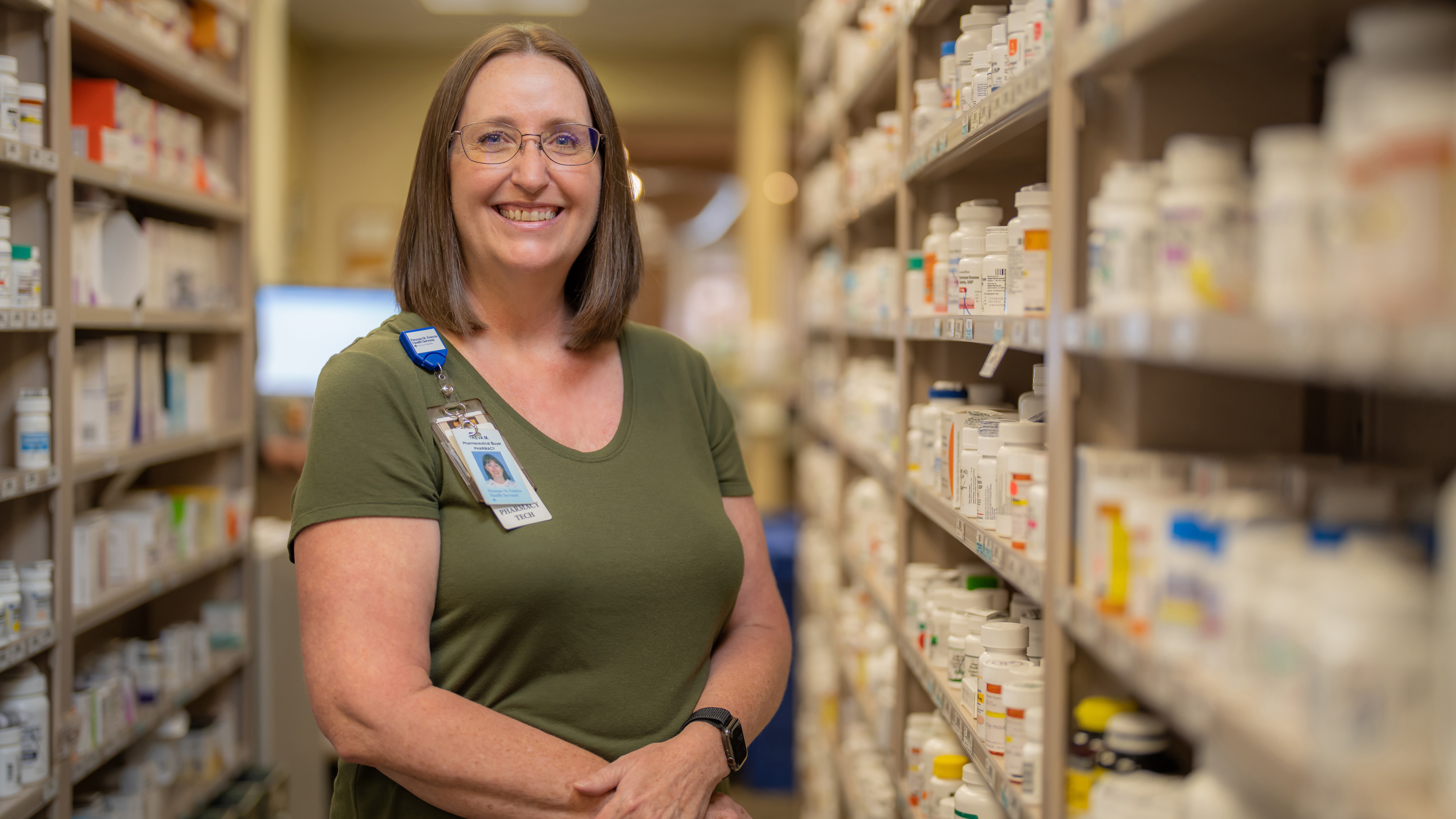 Smiling employee in the PSF pharmacy
