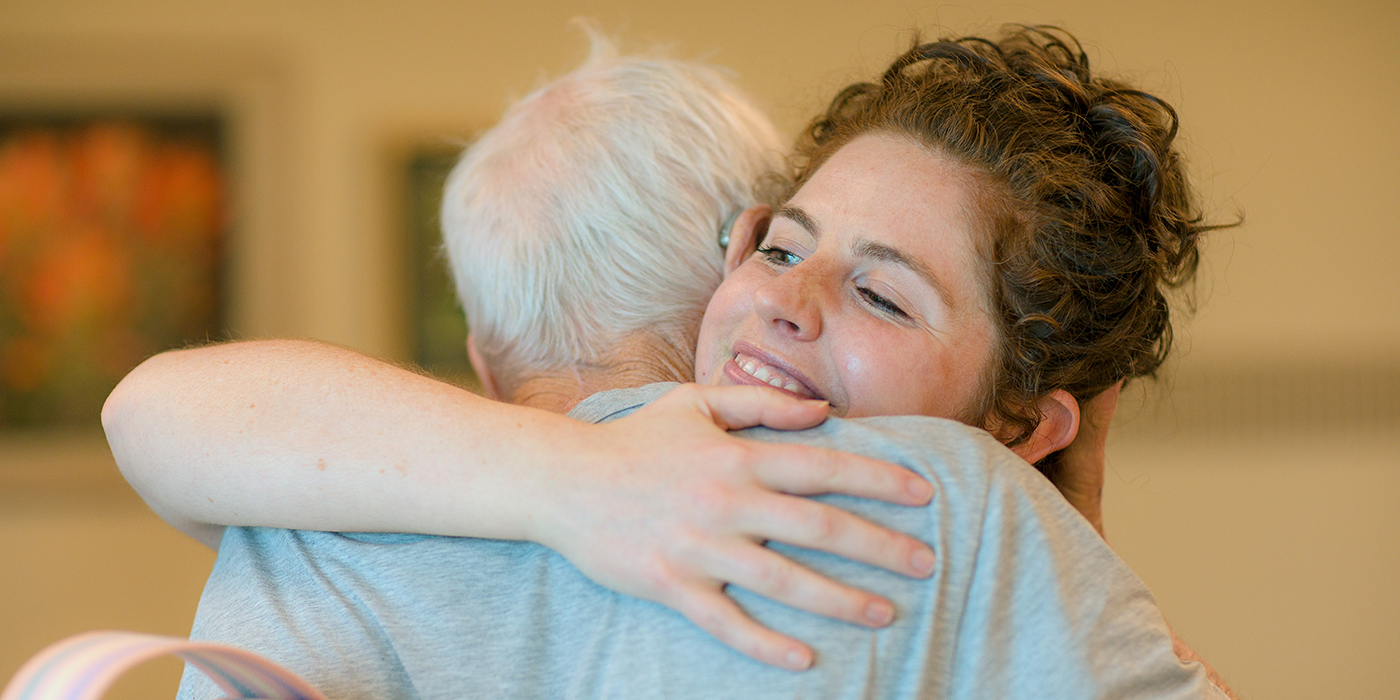 Caregiver giving a hug to a patient